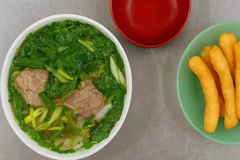 Pho served the local way, paired with fresh herbs, lime, chili, and crispy dough sticks for the perfect Hanoi pho experience